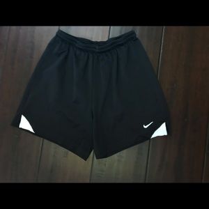 Black, mid-thigh, athletic Nike shorts